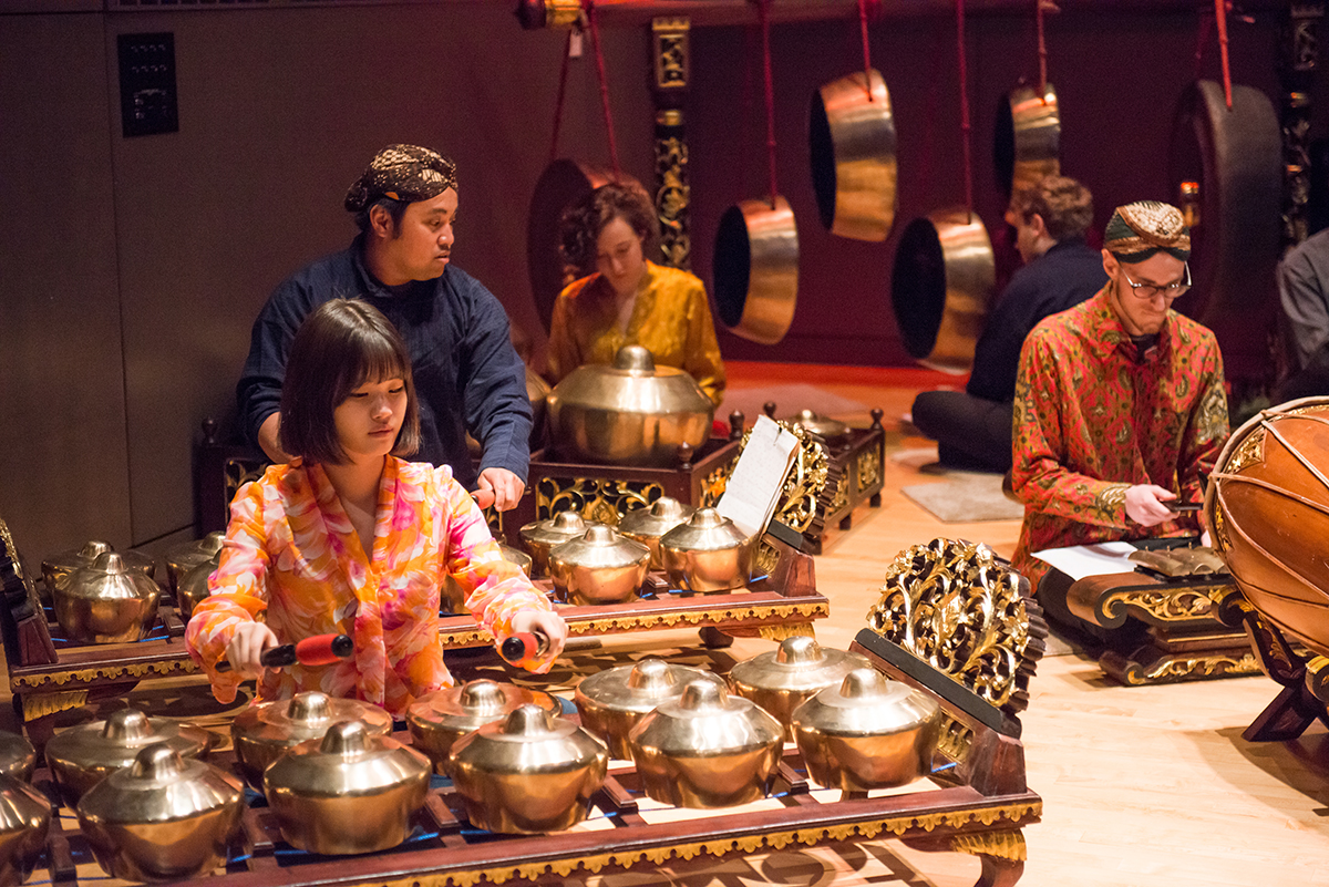 Musicians perform on a gamelan.