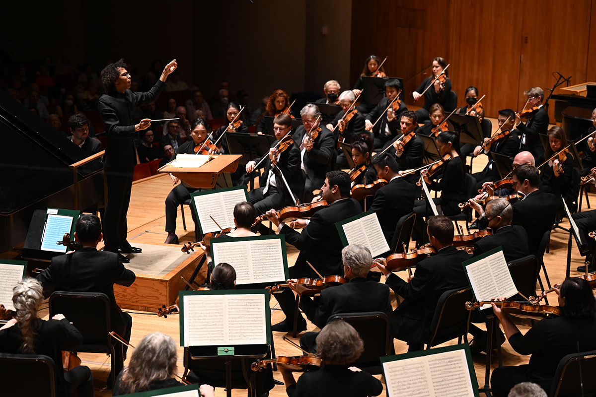 Maestro Jonathon Heyward conducts the Baltimore Symphony Orchestra on stage during a performance.